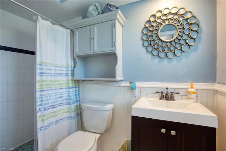 Bathroom featuring vanity, a shower with curtain, and toilet