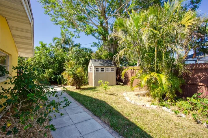View of yard with a patio area and a storage shed