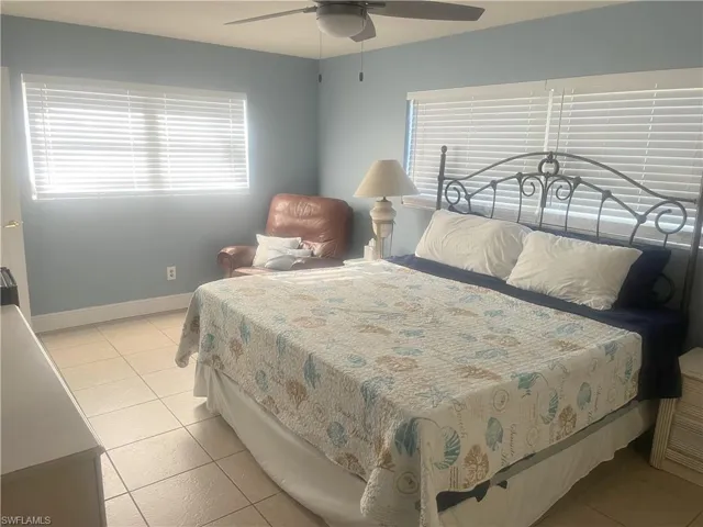 Bedroom featuring light tile patterned flooring and a ceiling fan