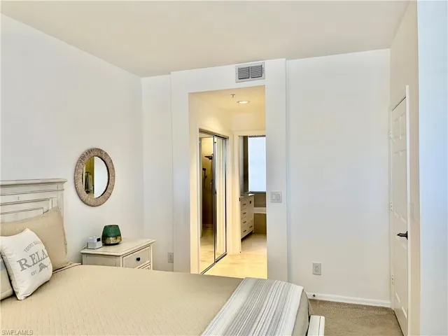 Bedroom featuring light colored carpet and baseboards