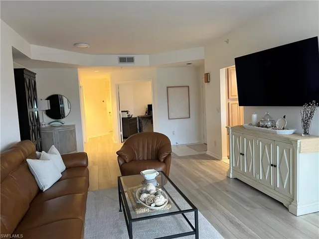 Living area with light wood-type flooring and baseboards