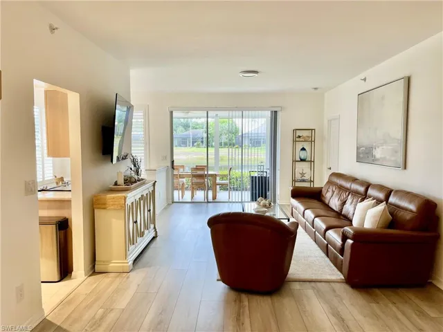Living area with light wood-style floors and baseboards