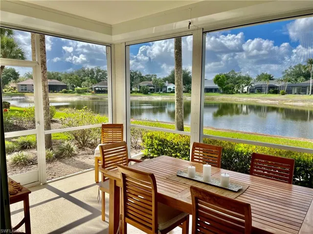 Sunroom featuring a water view