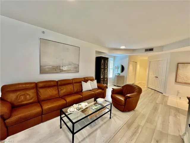 Living area featuring light wood-style flooring and baseboards