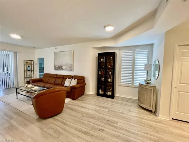 Living area featuring light wood-style flooring and baseboards