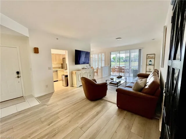 Living room with light wood-style floors and baseboards