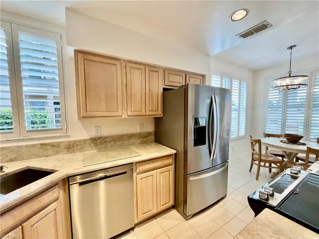 Kitchen featuring stainless steel appliances, light brown cabinetry, plenty of natural light, and recessed lighting