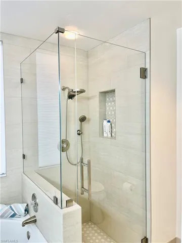 Bathroom featuring a stall shower and a bath