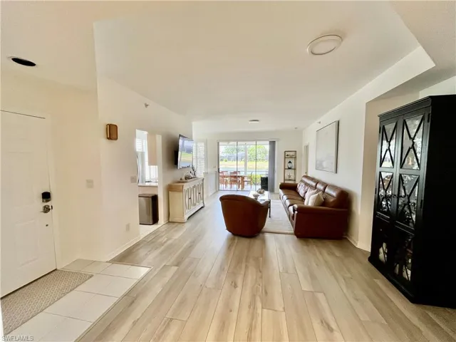 Living room featuring light wood-type flooring and baseboards