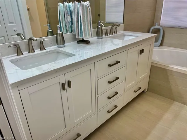 Bathroom with double vanity and a bath