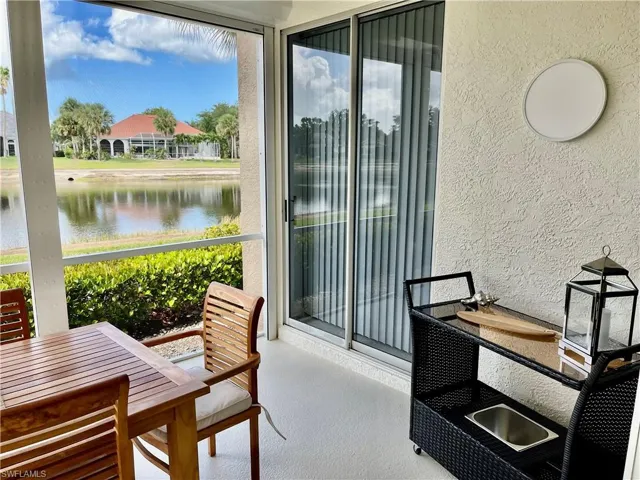 Sunroom featuring a water view