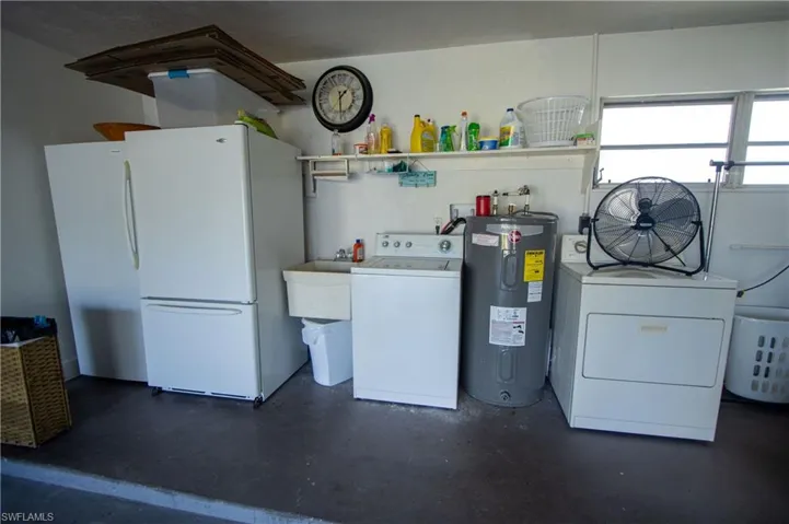 Clothes washing area with independent washer and dryer, sink, and water heater