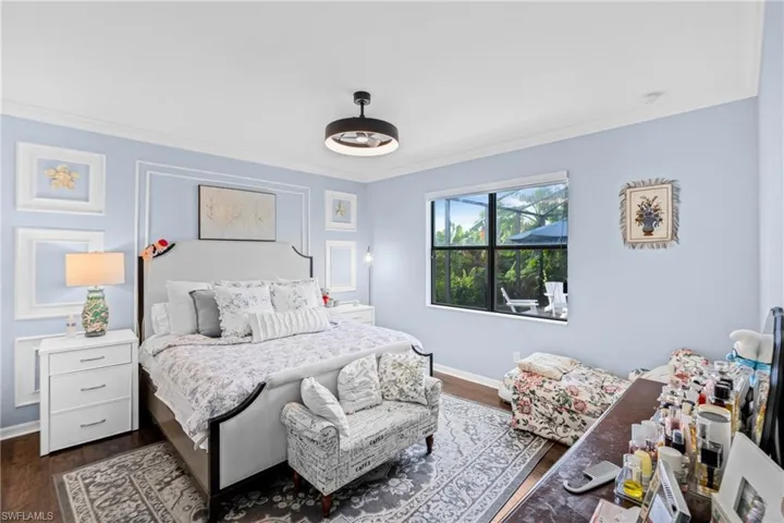 Bedroom featuring ornamental molding and dark wood-style floors