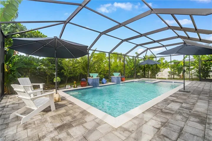 Integrated pool / hot tub with glass enclosure, a sunroom, and a patio