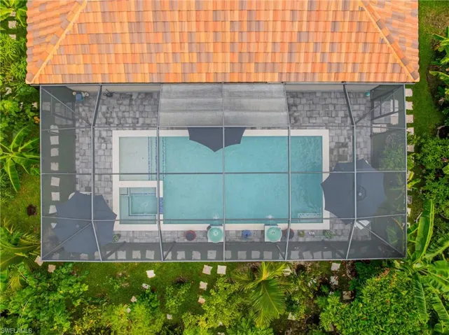 View of subject property with a pool area
