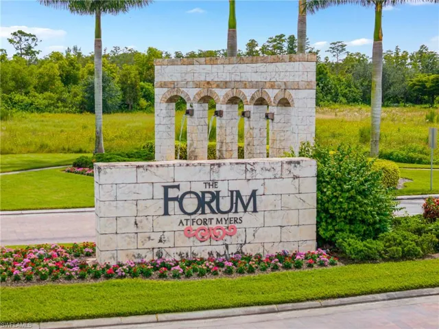 Community / neighborhood sign featuring a yard