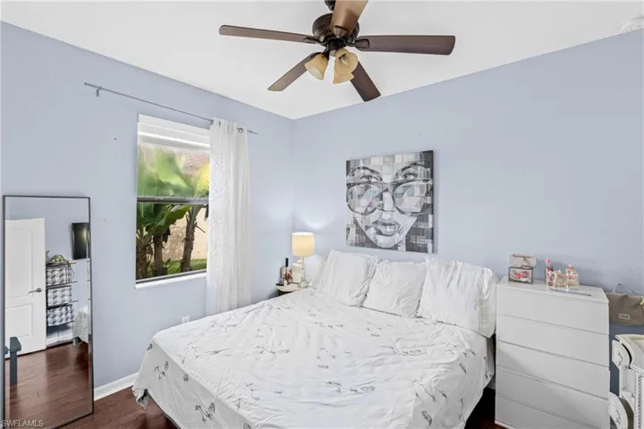 Bedroom featuring dark wood-type flooring and ceiling fan
