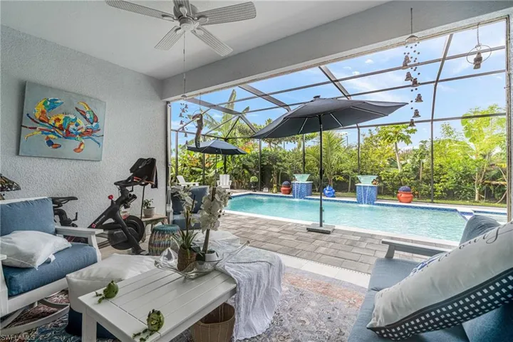 Outdoor pool featuring a sunroom, a lanai, and a patio