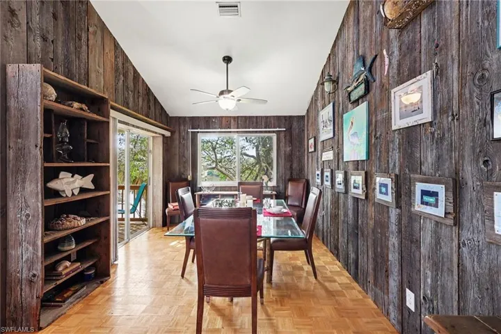 BLUE BAYOU A:  DINING AREA WITH EASTERN EXPOSURE WINDOW.  ENTRANCE TO COVERED DECK W/LAKE VIEWS IS SHOWN AT LEFT.  "BARN WOOD" STYLE WALLS.