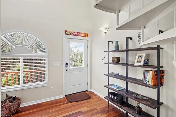 BLUE BAYOU B ENTRANCE.  WOOD FLOORING.  SUNBURST HALF MOON WITH WITH BLINDS.  IMPACT RESISTANT WINDOWS.