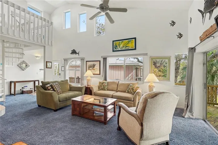 BLUE BAYOU A:  MAIN LIVING AREA WITH CLERESTORY WINDOWS.  SUNBURST AND CORNER WINDOWS.  STAIRCASE AND LOFT AREA SHOWN AT LEFT.  ENTRANCE TO COVERED DECK AREA IS TO RIGHT.