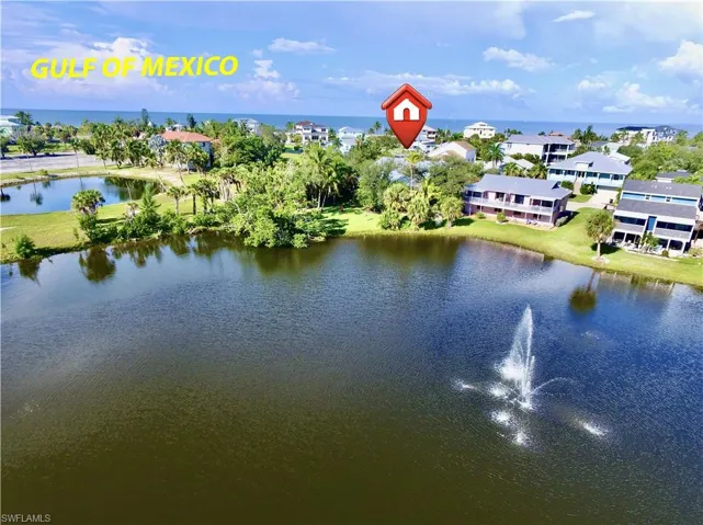 WATERFRONT PROPERTY W/LUSH GREEN LANDSCAPING BACKING UP TO A POND W/ACTIVE FOUNTAIN