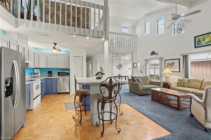 BLUE BAYOU A:  VIEW FROM DINING AREA INTO KITCHEN AND MAIN LIVING AREA.  BREAKFAST BAR. HALLWAY AT MIDDLE REAR LEADS TO BEDROOMS.