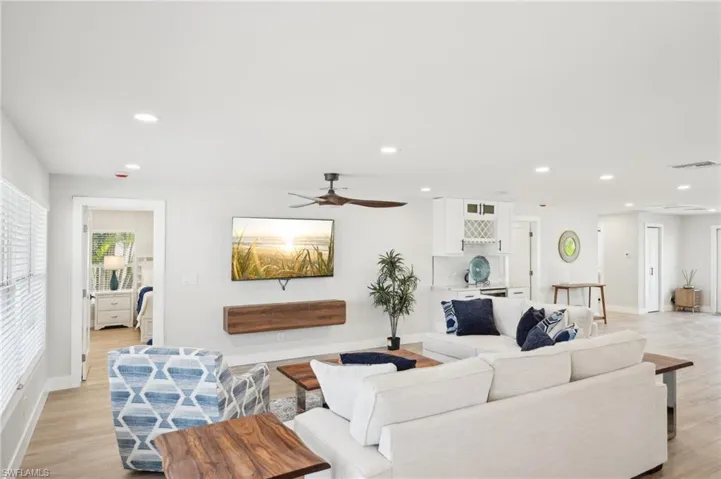 Living room featuring recessed lighting, baseboards, light wood finished floors, and ceiling fan