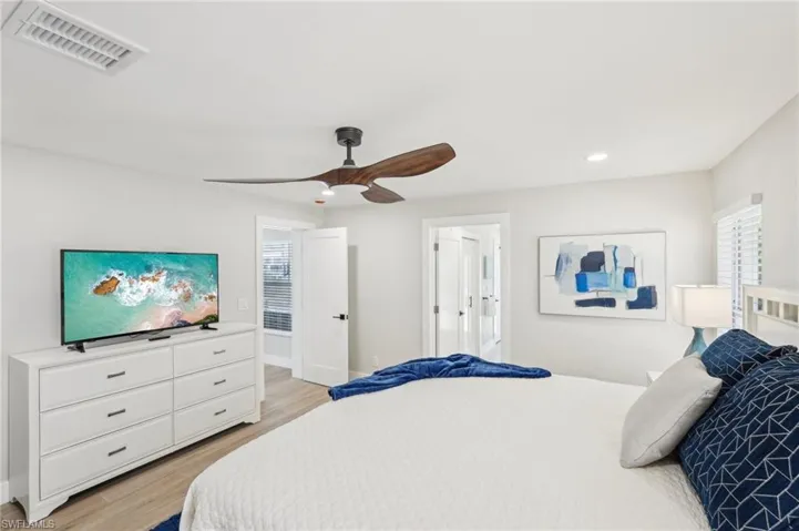 Bedroom featuring light wood-type flooring, recessed lighting, a ceiling fan, and baseboards