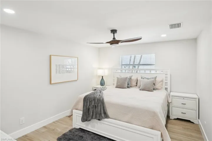 Bedroom featuring light wood-style flooring, baseboards, recessed lighting, and ceiling fan