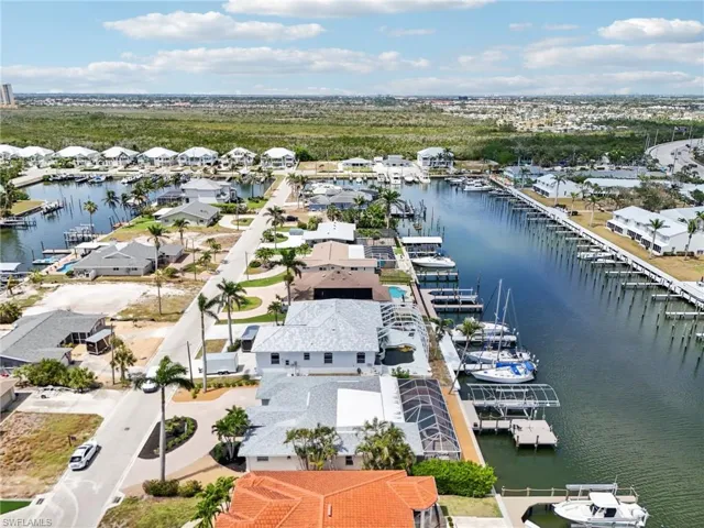 Aerial perspective of suburban area featuring a large body of water