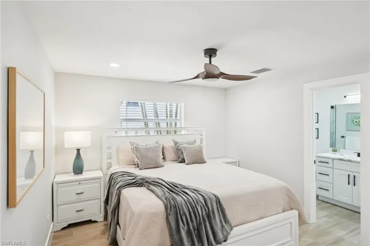 Bedroom featuring light wood-style flooring, connected bathroom, recessed lighting, a ceiling fan, and a sink