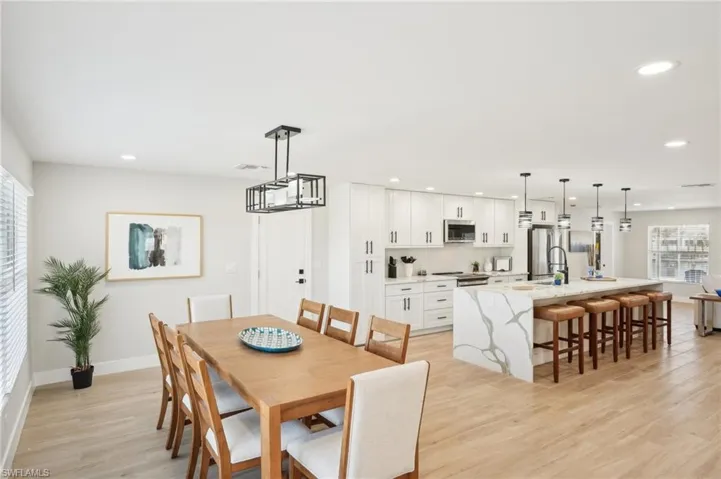 Dining room with recessed lighting, light wood-style floors, and baseboards