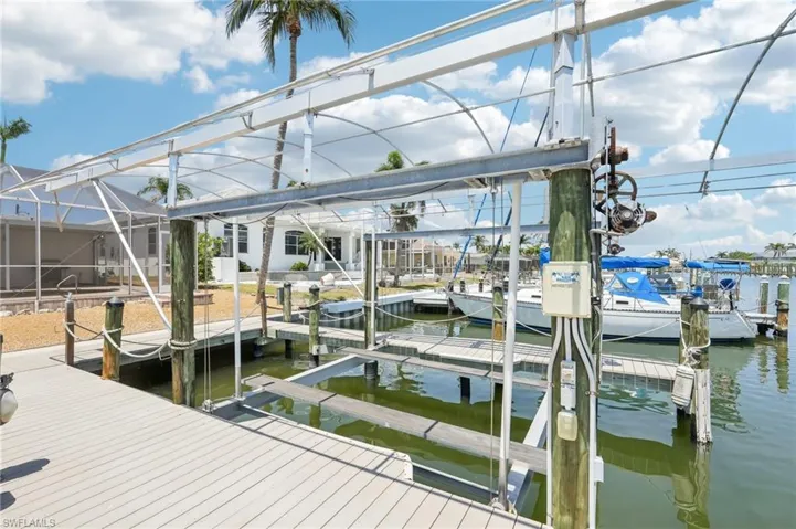 Dock area with a water view and boat lift