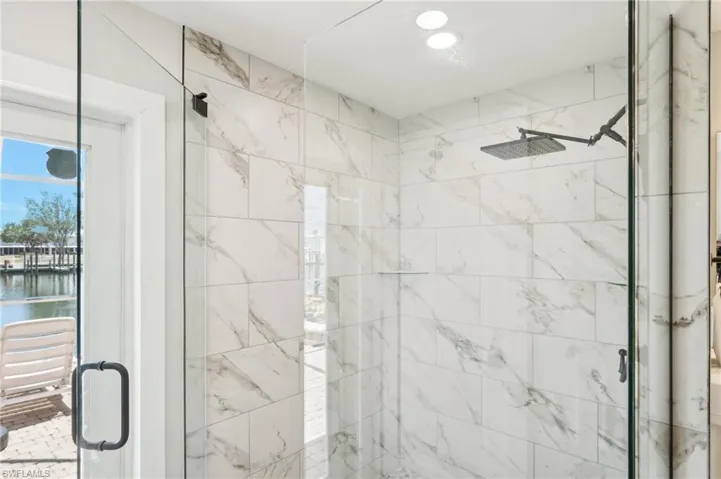 Bathroom with a stall shower and a water view