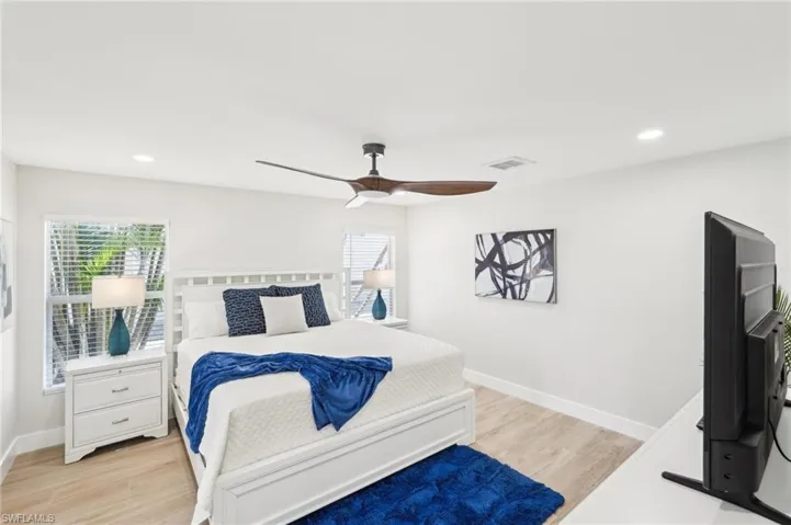 Bedroom with light wood-style flooring, baseboards, a ceiling fan, and recessed lighting
