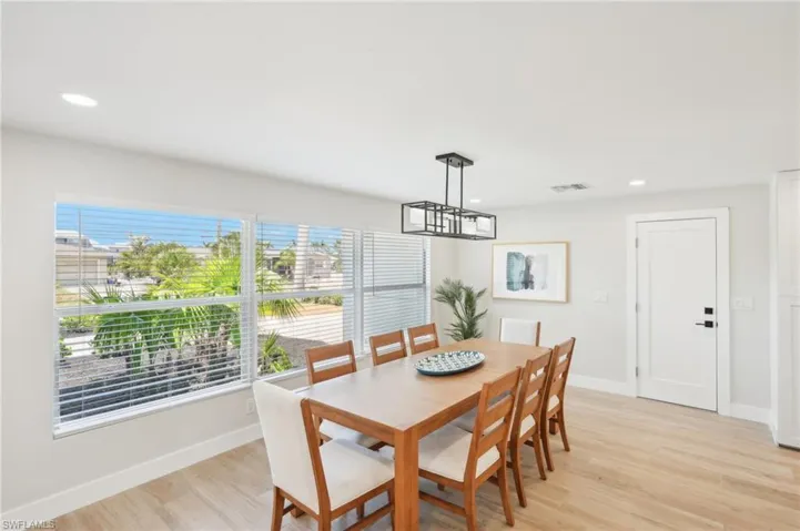 Dining area featuring light wood-type flooring, baseboards, and recessed lighting