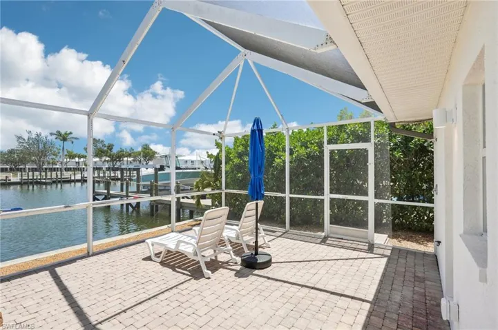 Unfurnished sunroom with a water view and lofted ceiling