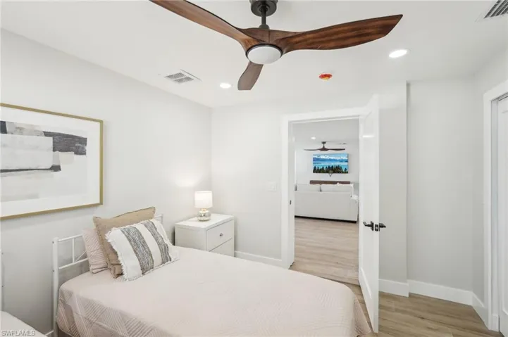 Bedroom featuring light wood finished floors, baseboards, recessed lighting, and a ceiling fan