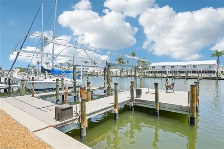 Dock area featuring boat lift and a water view