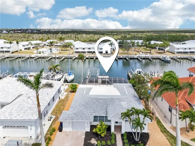 Aerial perspective of suburban area featuring a large body of water