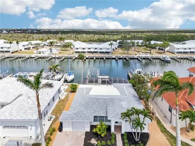 Aerial perspective of suburban area featuring a nearby body of water