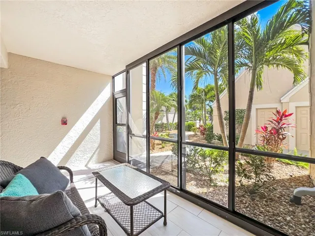 Front lanai .  Notice landscaped walkway and entry to garage across from lanai.