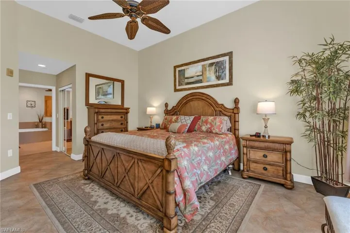 Bedroom featuring a closet, connected bathroom, and a ceiling fan