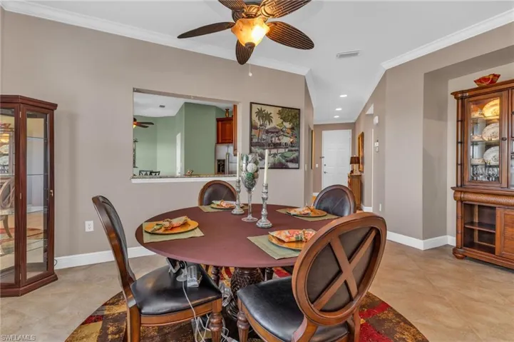 Dining area featuring recessed lighting, a ceiling fan, crown molding, and light tile patterned floors