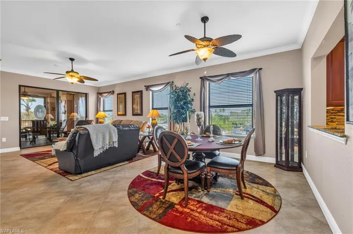 Dining area featuring a ceiling fan and ornamental molding
