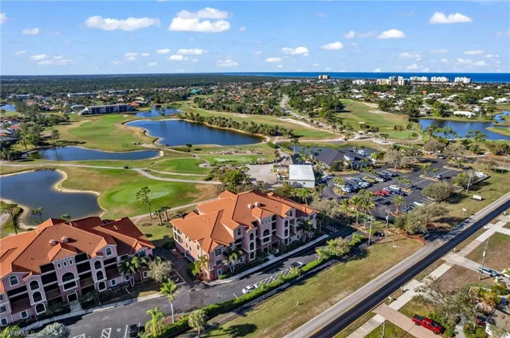Bird's eye view of a golf course and a nearby body of water