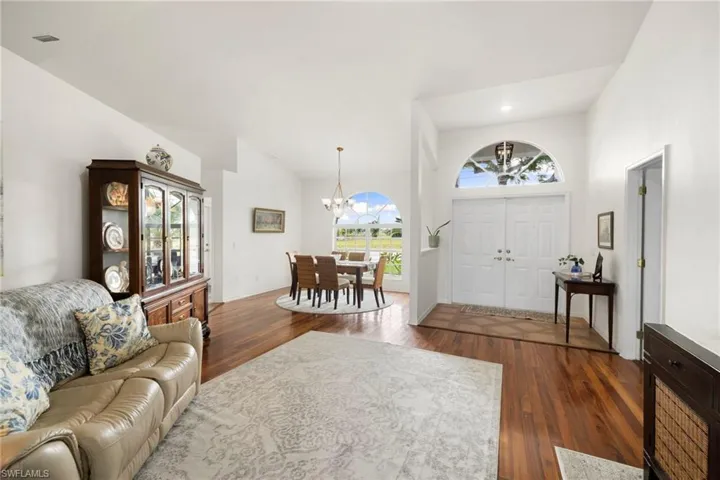 Entrance foyer featuring dark wood-type flooring, a chandelier, and recessed lighting