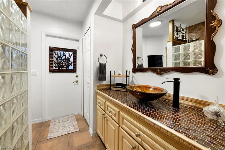 Bathroom featuring vanity and baseboards
