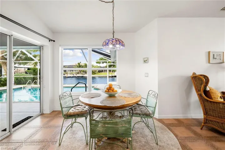 Dining room with a water view and inlaid floor details
